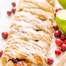 An Apple Danish Braid loaded with juicy caramelized apples and cranberries in a flaky pastry shell. This braided apple danish is easy and disappears fast! | natashaskitchen.com