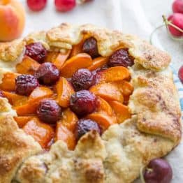 This apricot cherry galette is filled with the juicy apricots and sweet cherries with an easy and flaky pastry crust. Easy apricot cherry galette! | natashaskitchen.com