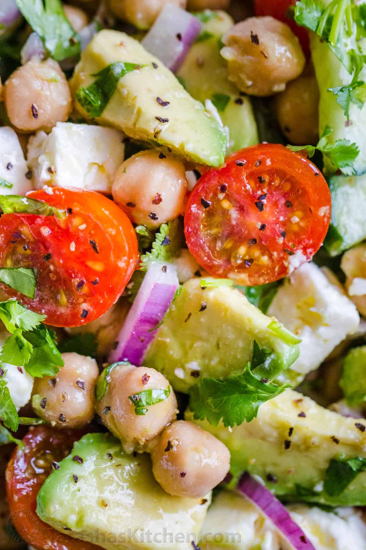 Chickpeas and garbanzo beans tossed with tomatoes, avocados, cucumber and red onion
