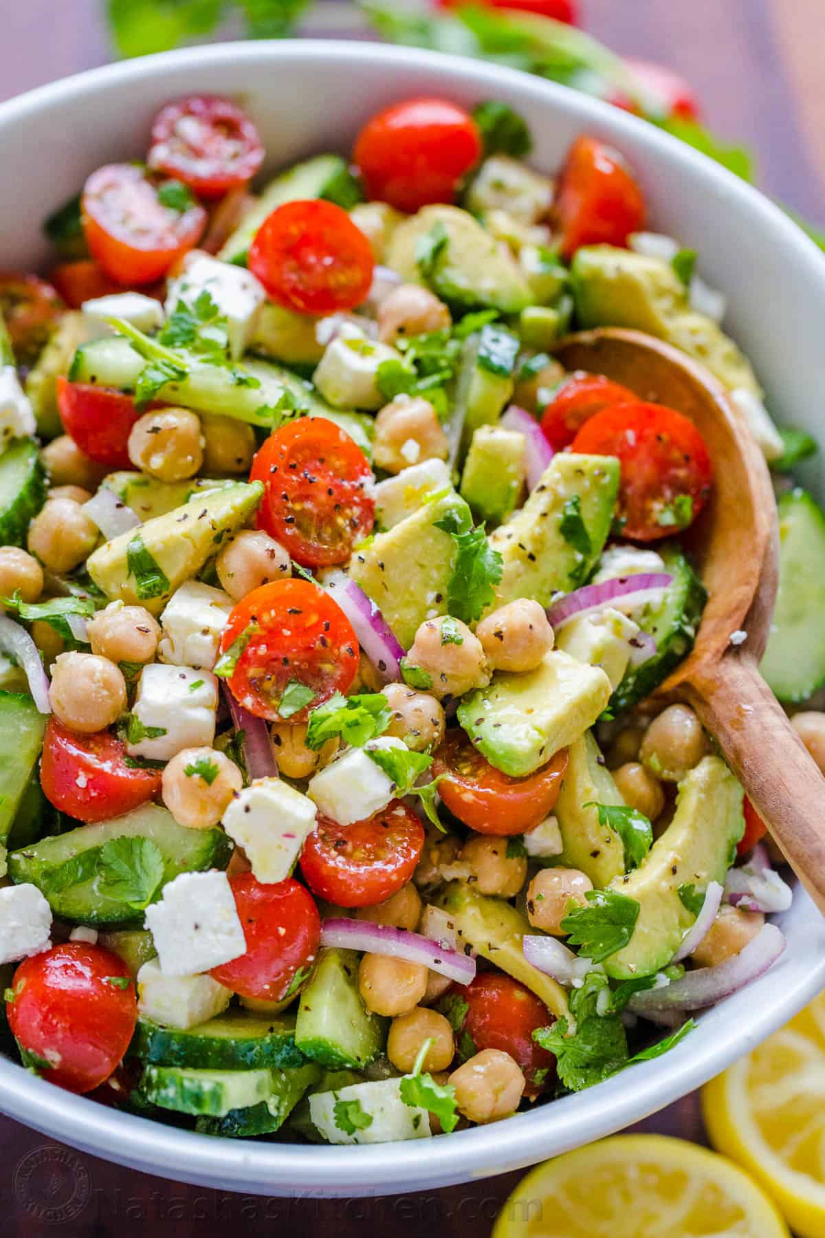 Chickpea Salad tossed together with lemon dressing in salad bowl