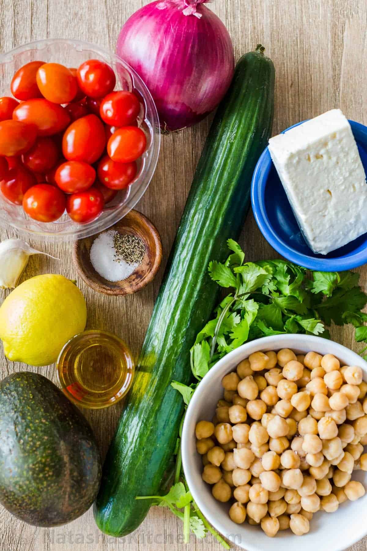 chickpea salad ingredients with healthy chickpeas, cucumber, tomato, avocado, cilantro and feta cheese