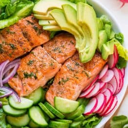 This avocado salmon salad recipe is loaded with all of the best salad ingredients; crisp cucumber and lettuce, and juicy pan seared salmon. The lemon dill dressing is so easy and gives this salmon salad amazing fresh flavor. | natashaskitchen.com