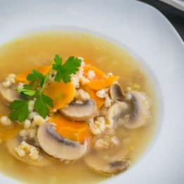 A bowl of barley and mushroom soup