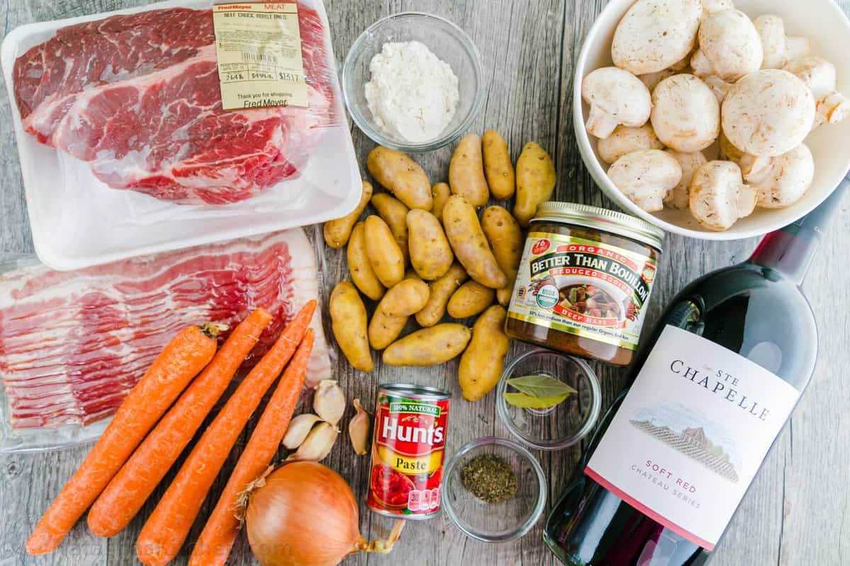 Ingredients for making beef stew with beef, bacon, potatoes, red wine, beef stock