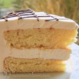 This ptichye moloko cake has mousse sandwiched between biskvit cake layers with a light syrup and a very simple creme chantilly frosting.