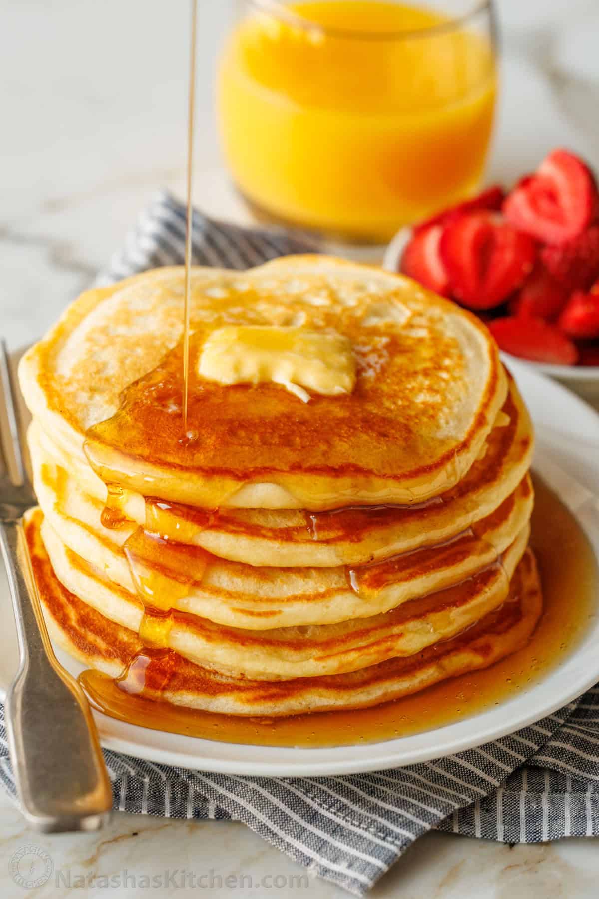 Fluffy Homemade Buttermilk Pancakes are the perfect breakfast. This pancake recipe is quick and easy to make (done in less than 30 minutes!) A stack of homemade buttermilk pancakes drizzled with syrup