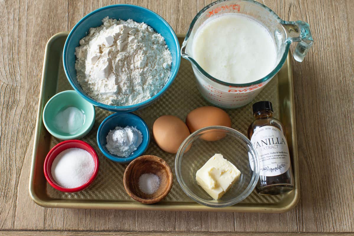 Fluffy Homemade Buttermilk Pancakes are the perfect breakfast. This pancake recipe is quick and easy to make (done in less than 30 minutes!) Ingredients for making griddle cakes with butter milk, eggs, baking soda and baking powder, flour, sugar, and vanilla extract