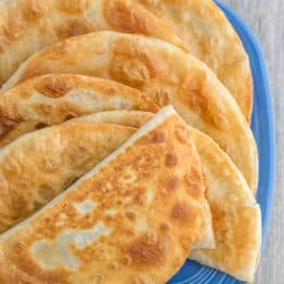 A close-up plate of cabbage and mushroom chebureki