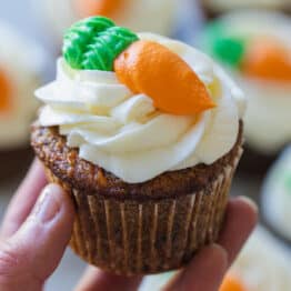 Carrot cake cupcake frosted and decorated with carrot
