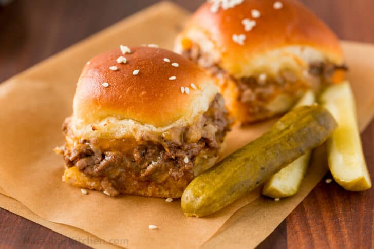 Cheeseburger Sliders are juicy, cheesy and beefy and everything we love about burgers. Sliders are quick and easy, make-ahead, and reheat really well. Cheeseburger sliders served with sliced pickles