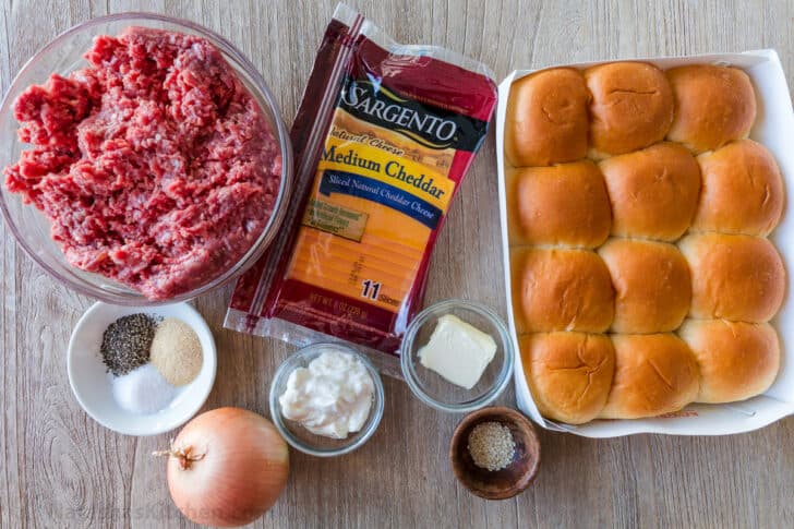 Cheeseburger Sliders are juicy, cheesy and beefy and everything we love about burgers. Sliders are quick and easy, make-ahead, and reheat really well. Ingredients for mini cheeseburgers with Hawaiian dinner rolls, ground beef, cheese, mayo, onion, seasonings, butter and sesame seeds