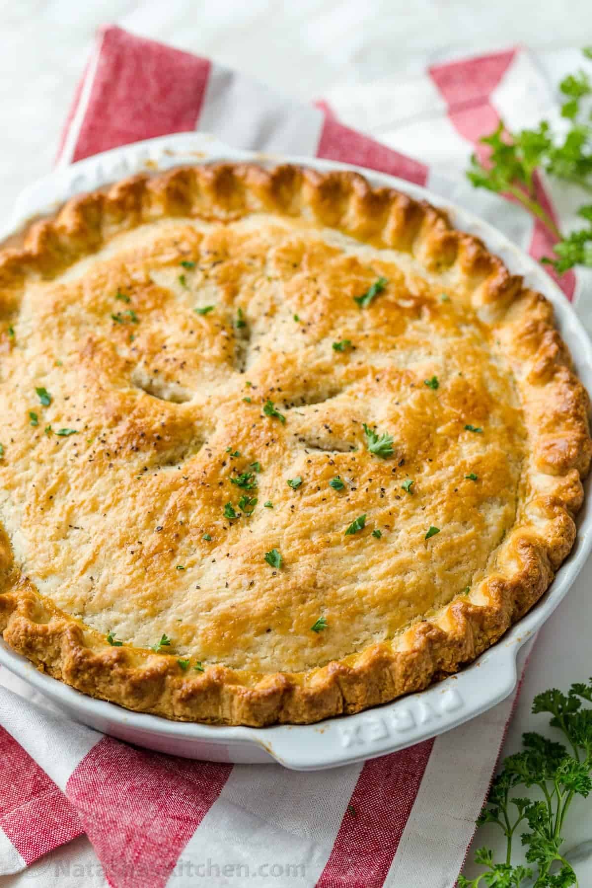 Chicken Pot Pie Recipe with a flaky crust, filled with juicy chicken and veggies in gravy. Homemade Chicken Pot Pie is a classic comfort food. Chicken Pot Pie garnished with parsley