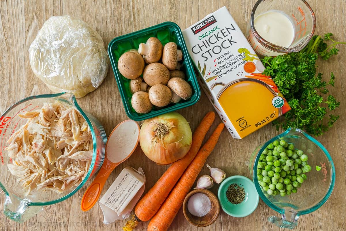 Ingredients for Chicken Pot Pie Recipe with a flaky crust, filled with juicy chicken and veggies in gravy. Homemade chicken pot pie is classic comfort food. Ingredients for chicken pot pie with chicken, mushrooms, carrot, onion