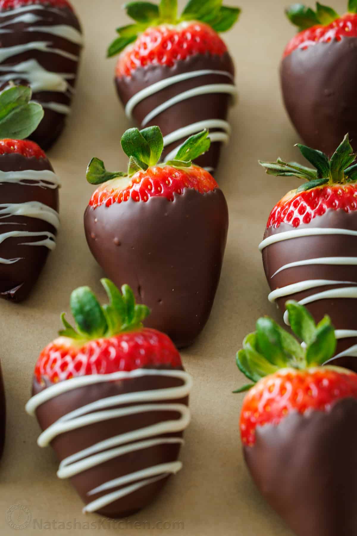How to make the BEST Chocolate Covered Strawberries. Everything you need to know for melting chocolate, dipping, and decorating strawberries. Homemade chocolate covered strawberries resting on a baking sheet