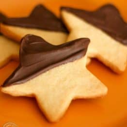 Four chocolate shortbread cookies on an orange plate