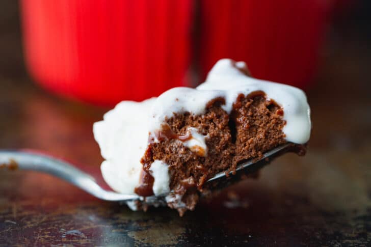 Chocolate Soufflé rises beautifully and is intensely chocolatey. Learn how to make Chocolate Soufflé with chocolate sauce and whipped cream. Spoonful of chocolate souffle with whipped cream