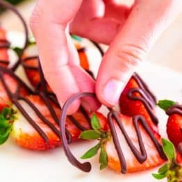 Decorating Cakes with Chocolate is quick, easy and all you need is chocolate chips, a sheet of parchment paper and something to pipe it with.