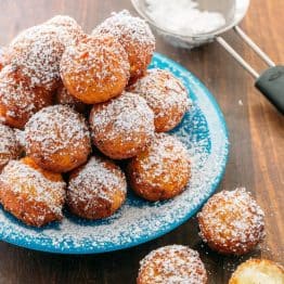 Billowy soft and lightly sweet Donut Holes (Russian Ponchiki). These donut holes are made with cheese giving them unforgettable flavor. Easy donut recipe!