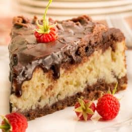 This Cheese Chocolate Cake has a generous layer of farmers cheese sandwiched between two layers of chocolate crust and covered with a chocolate glaze.