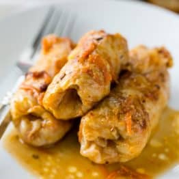 Our family loves these stuffed cabbage rolls. This step-by-step recipe makes it so easy! Absolutely delicious recipe for these cabbage rolls (golubtsi)
