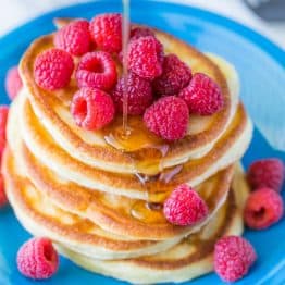 These Greek yogurt pancakes aren't your standard pancakes! They are delicate and crisp on the edges - delicious!| natashaskitchen.com