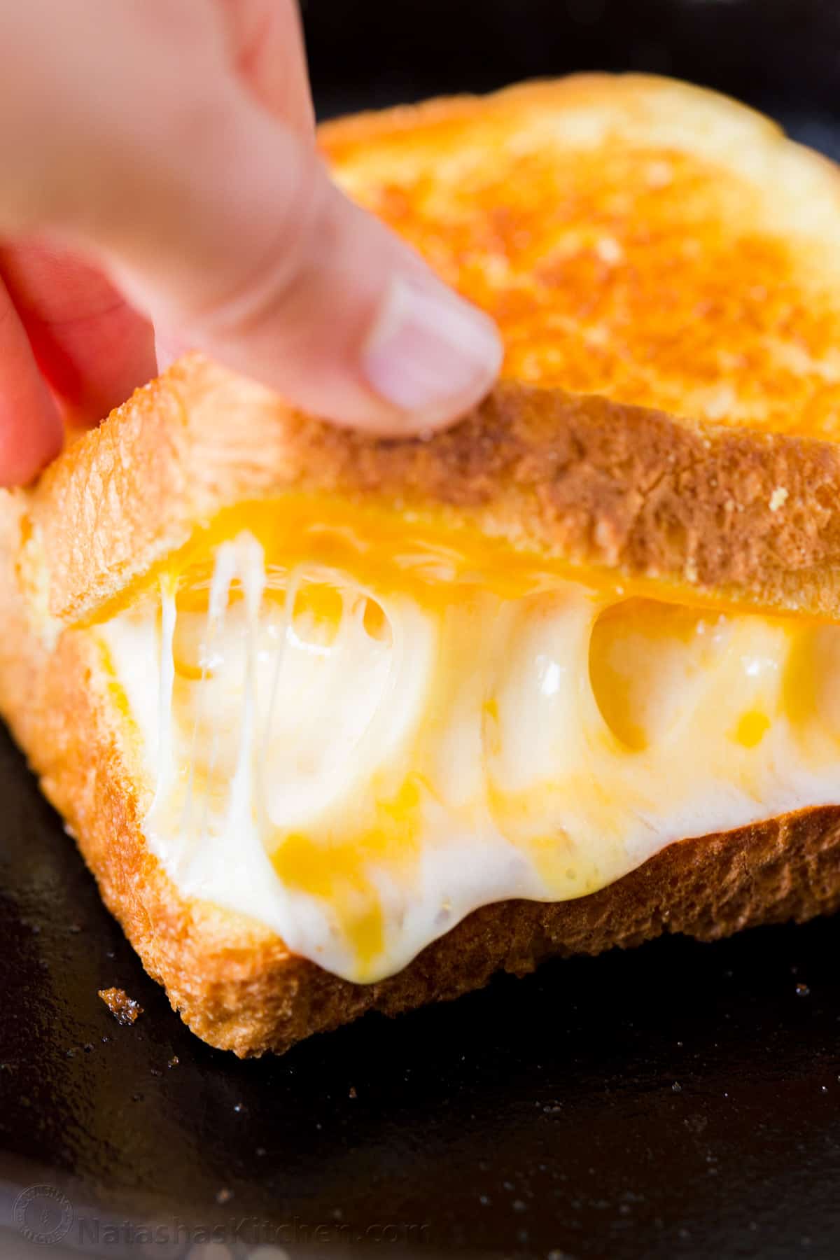 Learn how to make the best Grilled Cheese sandwich with a crisp, buttery exterior and gooey cheese center. Make grilled cheese like a pro! Melty cheese inside of a grilled cheese sandwich