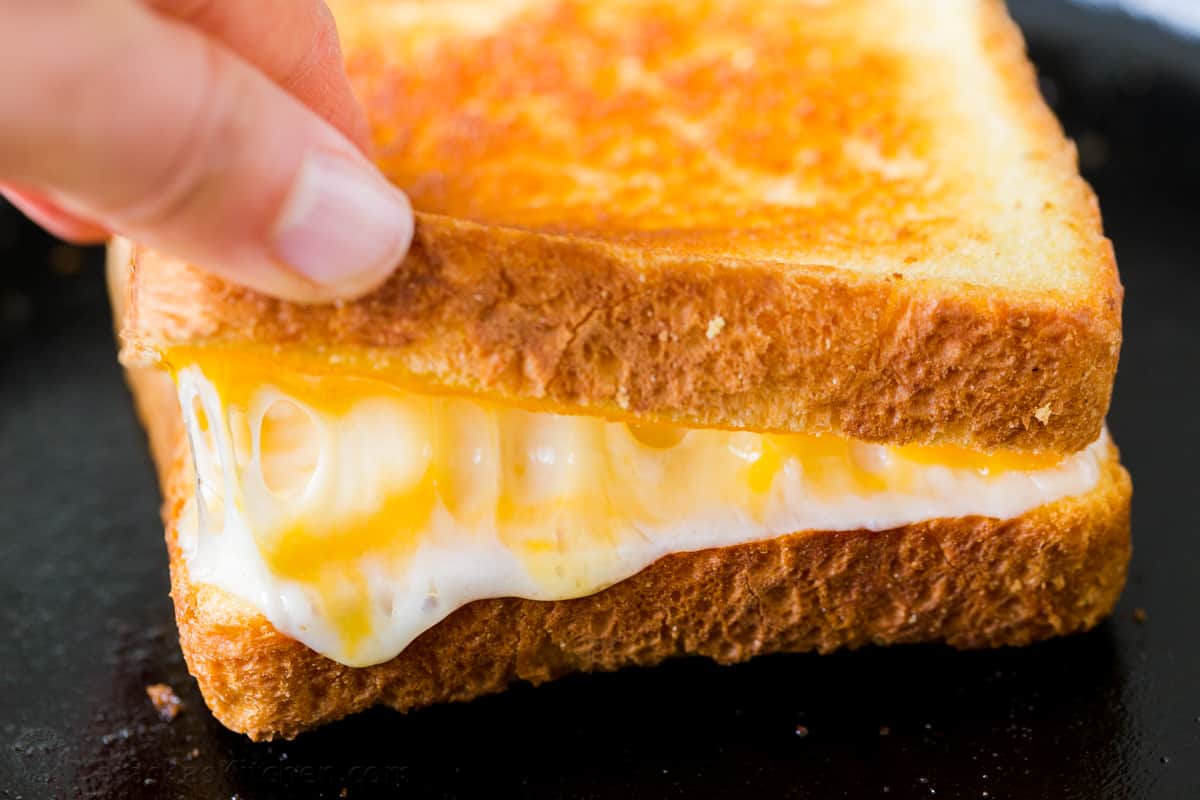 Learn how to make the best Grilled Cheese sandwich with a crisp, buttery exterior and gooey cheese center. Make grilled cheese like a pro! Grilled cheese reheated on skillet until cheese is melted