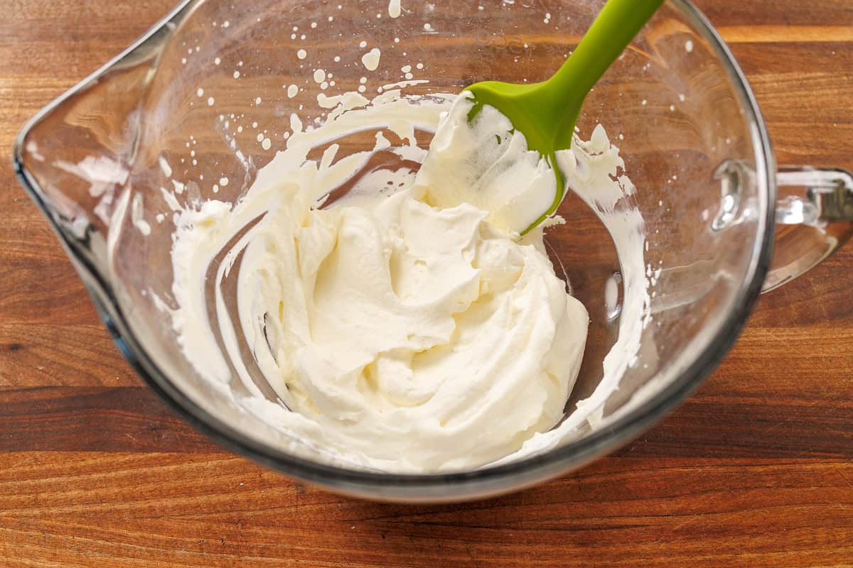 Make my Homemade Whipped Cream Recipe in less than 5 minutes with just 3 ingredients. Swap for Cool Whip for the best dessert dip or topping. easy whipped cream recipe in a mixing bowl
