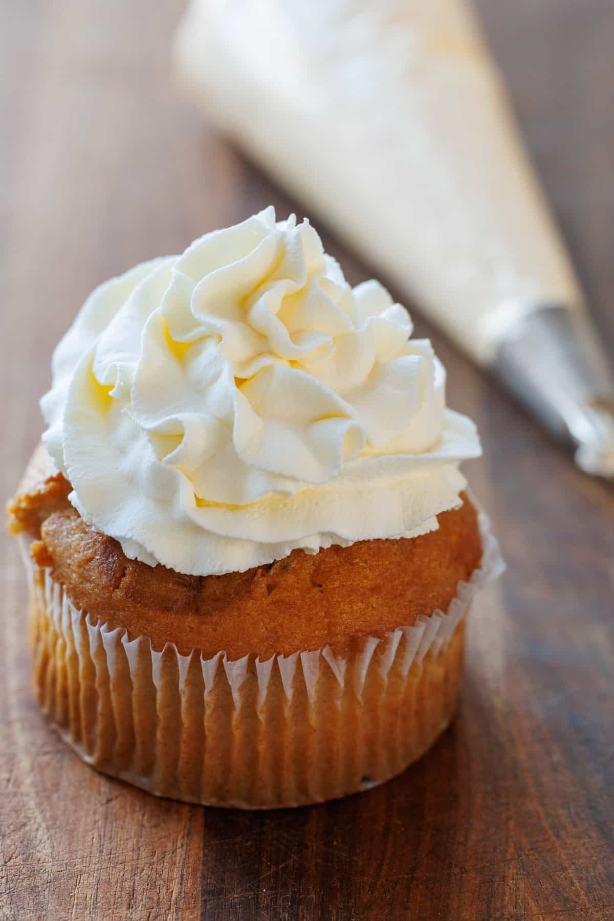 Make my Homemade Whipped Cream Recipe in less than 5 minutes with just 3 ingredients. Swap for Cool Whip for the best dessert dip or topping. Homemade dessert topping piped on top of a cupcake