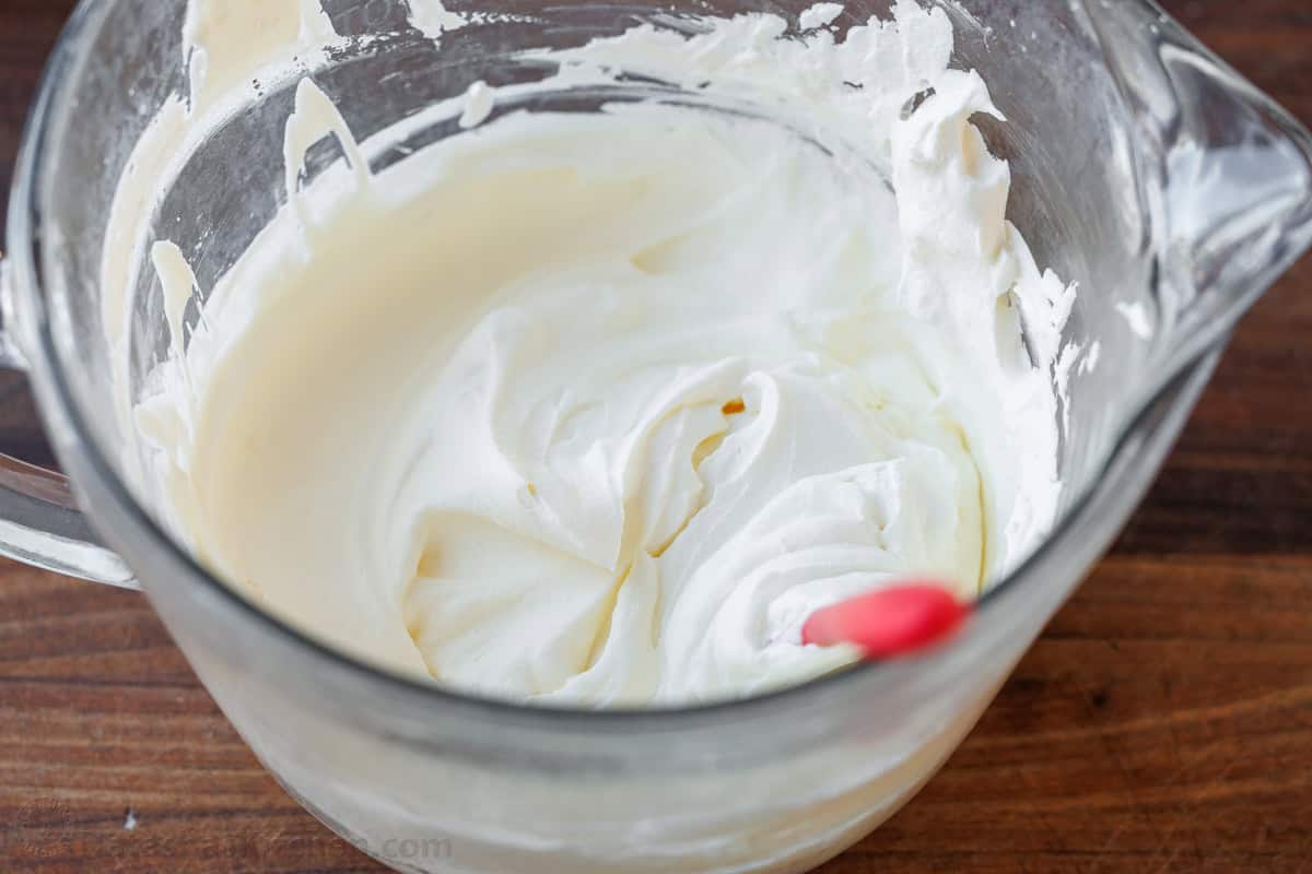 fluffy whipped cream in a mixing bowl