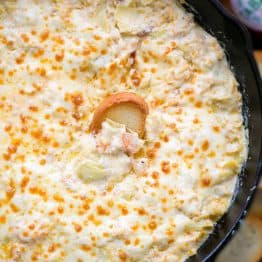 This Hot Shrimp Dip is the ultimate game day or party appetizer. It is creamy, cheesy and loaded with shrimp and artichokes.