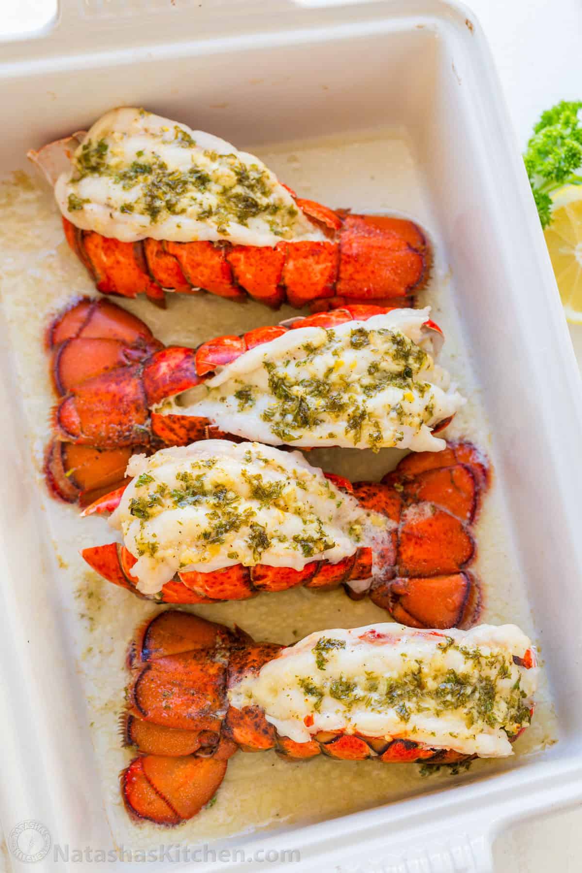 This Lobster Tail recipe with garlic butter sauce is juicy, flavorful, and easy. Includes an easy tutorial on how to butterfly lobster tail. Lobster tails broiled in a baking dish