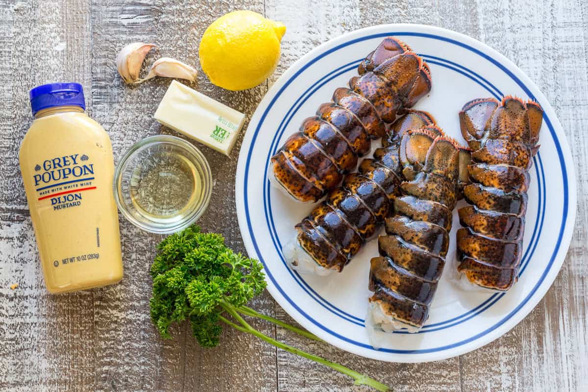This Lobster Tail recipe with garlic butter sauce is juicy, flavorful, and easy. Includes an easy tutorial on how to butterfly lobster tail. Ingredients for broiled Lobster tail with lemon butter, garlic, parsley and dijon