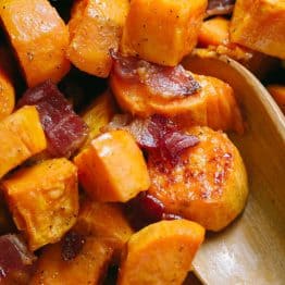 Maple Roasted sweet potatoes with bacon and serving spoon