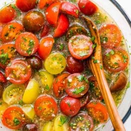 Marinated cherry tomatoes are a colorful, juicy and tasty side dish that is perfect for summer parties, buffets and large gatherings because it can be made hours in advance. This is one of our favorite cherry tomato recipes! Italian marinated tomatoes with just 4 ingredients! | natashaskitchen.com