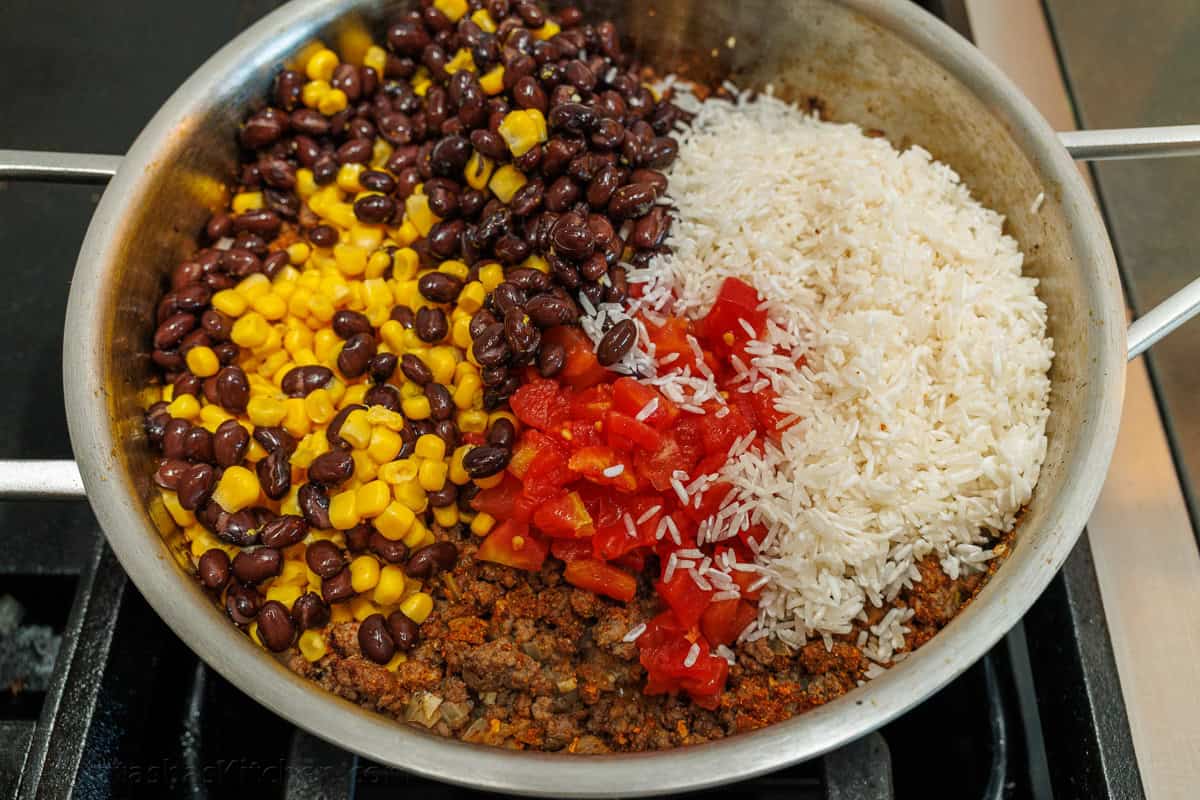 Mexican Ground Beef and Rice Skillet with the black beans, corn, rice, and Rotel tomatoes added to the ground beef.