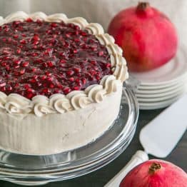 A moist Pomegranate Cake with a crown of glistening pom seeds. Pomegranate cake is fantastic top to bottom and makes for a stunning Christmas Cake! | natashaskitchen.com