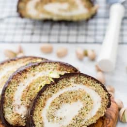 This moist poppyseed cake roll is generously filled with a cream cheese frosting, covered with velvety chocolate ganache and pummeled with salted pistachios. It’s moist, sweet, tangy, chocolaty and a teensy bit salty. We have a winner!