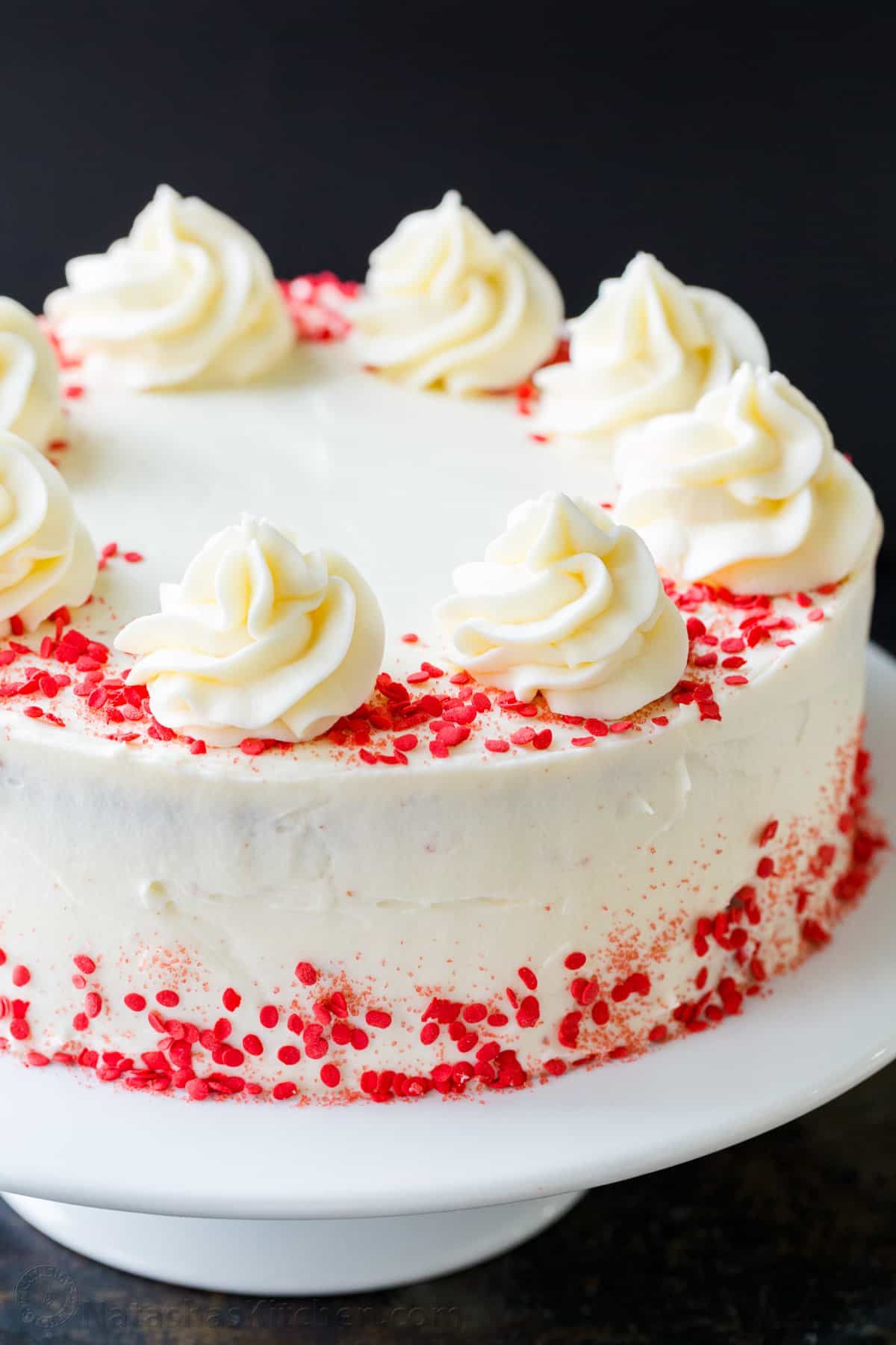 Our homemade Red Velvet Cake has a soft and moist crumb with the best Cream Cheese Frosting. Perfect for Valentine's, birthdays, or any special occasion. How to decorate red velvet cake with sprinkles and cream cheese frosting