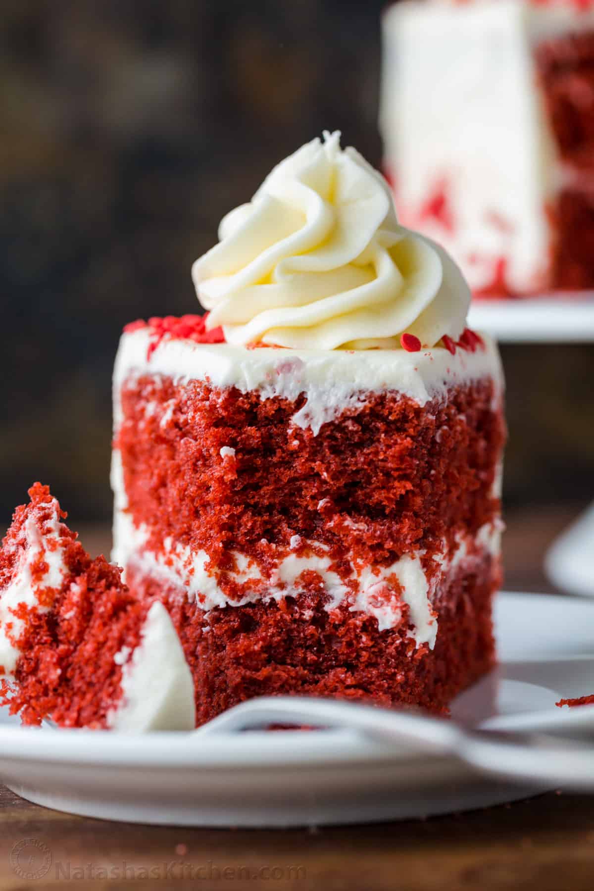 Our homemade Red Velvet Cake has a soft and moist crumb with the best Cream Cheese Frosting. Perfect for Valentine's, birthdays, or any special occasion. Up close slice of red velvet cake with fork