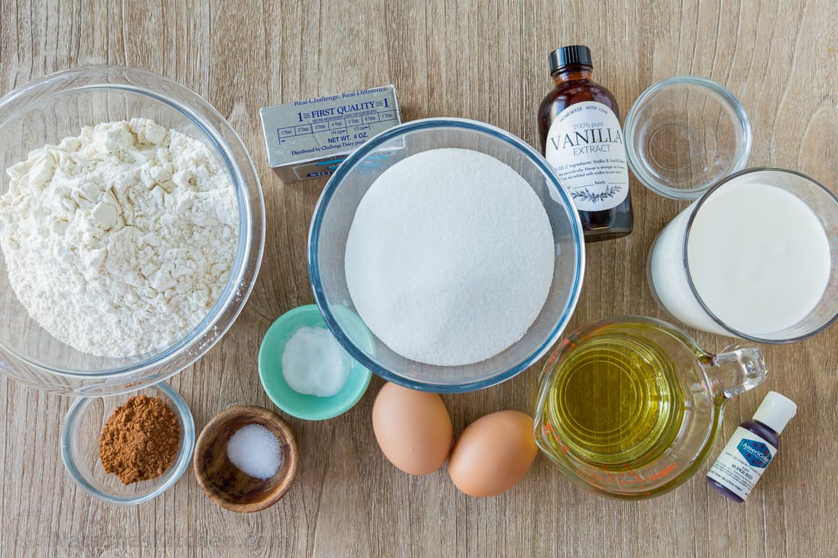 Ingredients to make a homemade red velvet cake Ingredients for red velvet cake with cocoa, flour, sugar, eggs, oil, butter, buttermilk, vinegar, baking soda
