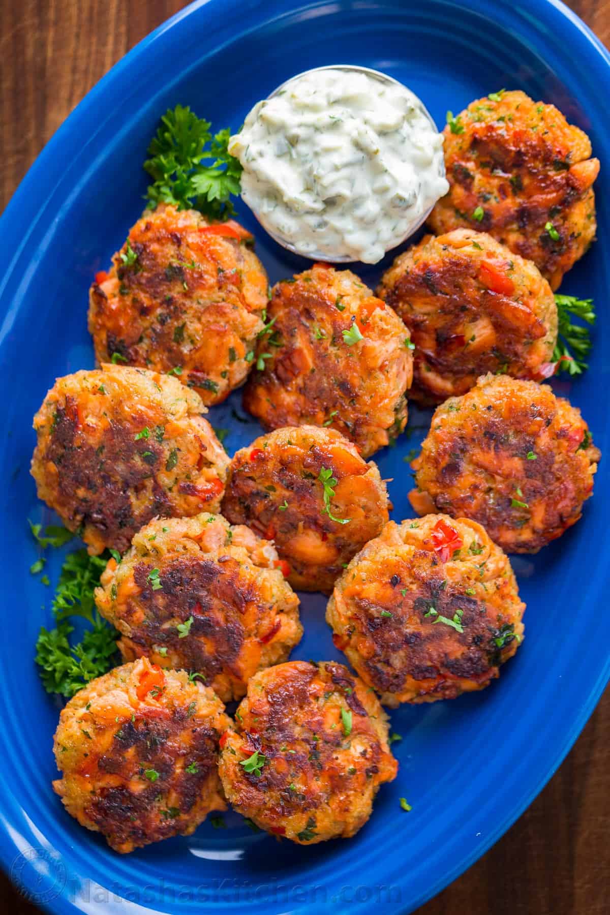 Salmon Patties are easy to make with leftover or canned salmon. They're flaky, tender, flavorful, and perfect as an appetizer or main dish. Salmon Patties on a plate with tartar dipping sauce.
