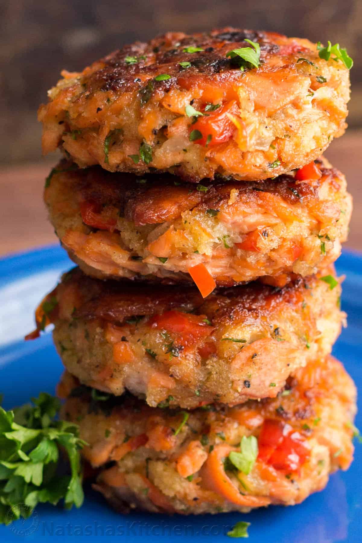 Salmon Patties are easy to make with leftover or canned salmon. They're flaky, tender, flavorful, and perfect as an appetizer or main dish. Salmon patties recipe stacked on top of each other on a blue plate