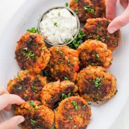 These salmon cakes are crisp on the outside with tasty bites of flaked salmon. They always disappear fast! SUPER EASY and truly delicious salmon cakes! | natashaskitchen.com