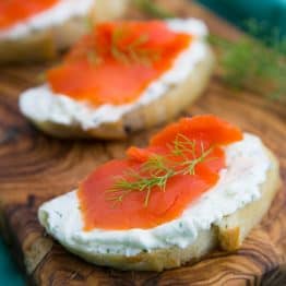 These smoked salmon tea sandwiches (crostini) show up at 90% of our parties. Everyone loves them. The cream cheese dill spread is wonderful!