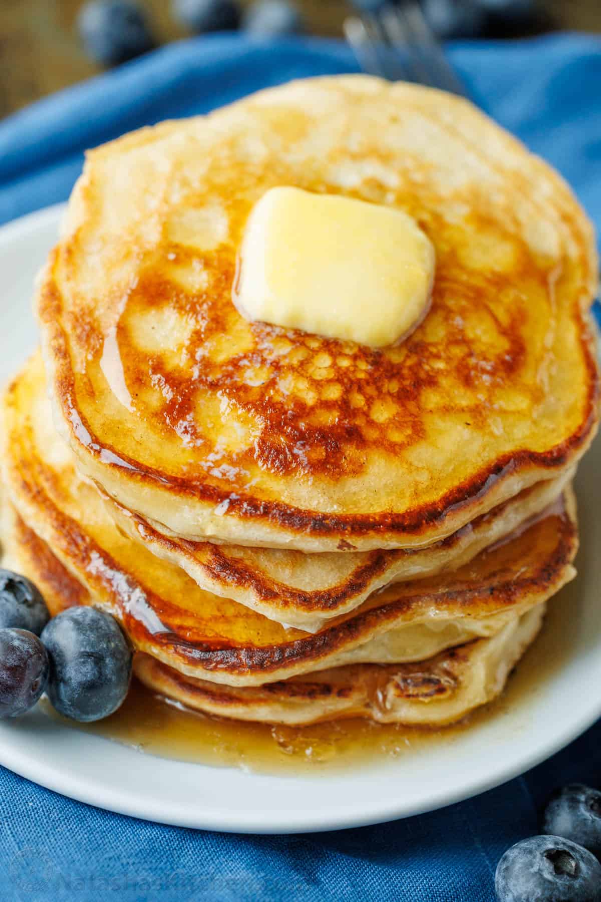Overnight Sourdough Pancakes are easy! Mix everything before bed, leave at room temp overnight, and wake up to bubbly, ready-to-cook pancake batter. Sourdough pancakes served with fresh blueberries