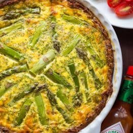 Every bite of this Sausage Asparagus Quiche is pure comfort. This classic quiche recipe is loaded with juicy sausage, eggs, fresh asparagus and herbs. | natashaskitchen.com