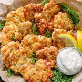 The cheese in these chicken fritters forms a crisp outer crust and a lovely cheese pull as you bite into these yummy chicken fritters. Juicy and delicious chicken patties!