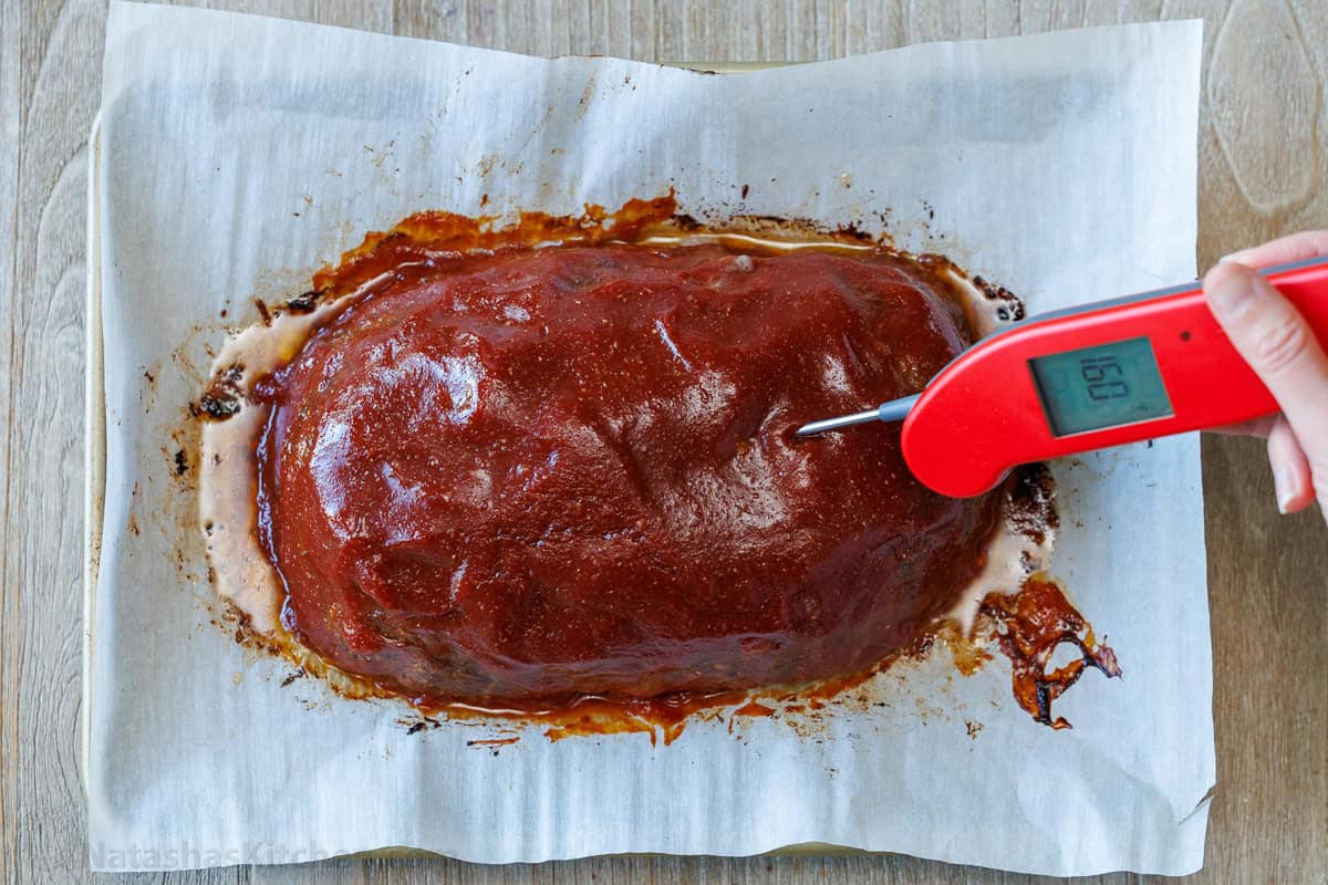 Amazing homemade Meatloaf Recipe. The meatloaf is so tender and juicy on the inside with a sweet and tangy sauce that glazes the meatloaf and adds so much flavor! #meatloaf #meatloafrecipe #howtomakemeatloaf #glazedmeatloaf #meatloafsauce #bestmeatloaf #natashaskitchen #groundbeef Testing meatloaf doneness with instant-read thermometer