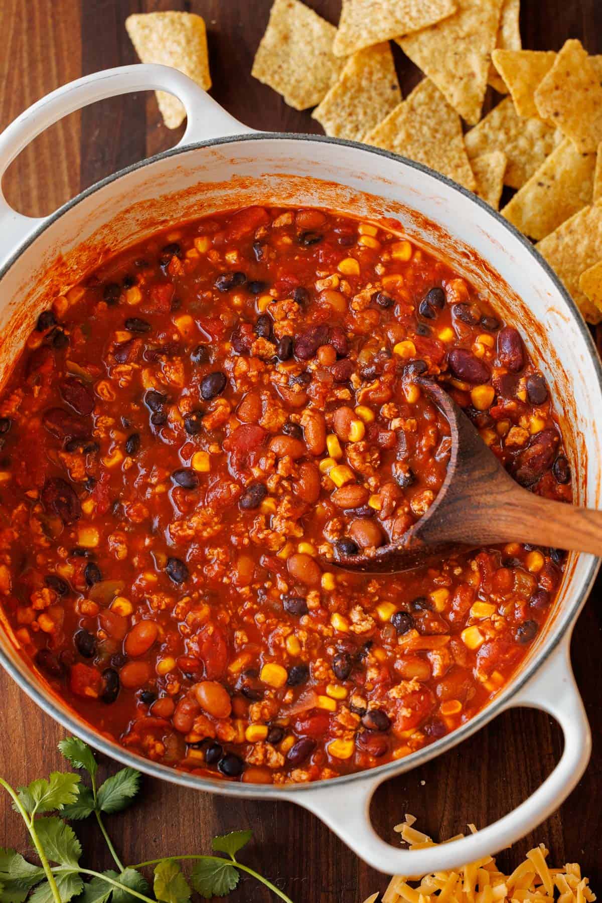 pot of turkey chili in a Dutch Oven with chips on the side